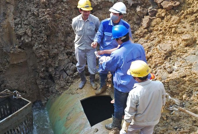Tối nay 'vá' xong đường ống nước sông Đà Các công nhân tiến hành cắt đường ống và vào bên trong để tìm điểm bị vỡ. Ảnh: Thanh Hà.
