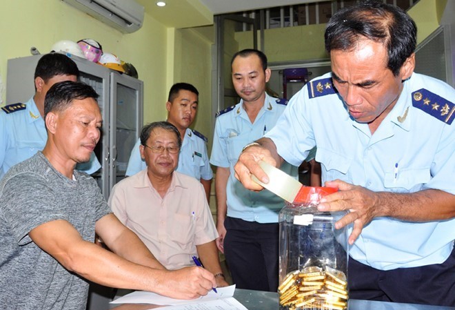 Công an An Giang tìm chủ sở hữu 18 kg vàng Rim Ri Linh (trái) ký vào biên bản bị bắt quả tang