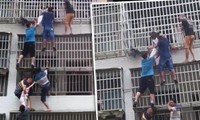 6 người ở Trung Quốc tạo thành “chiếc thang sống”, cứu 2 cô bé kẹt trong căn hộ bị cháy
