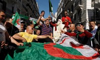 Người biểu tình Algeria mang theo cờ để phản đối tổng thống kéo dài nhiệm kỳ và trì hoãn bầu cử. (Ảnh: Reuters)