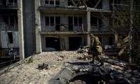 Một lính Ukraine khảo sát khu nhà hư hỏng ở thành phố Marinka thuộc vùng Donbas ngày 28/5. (Ảnh: Reuters)
