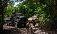 Binh lính và thợ máy thuộc Lữ đoàn cơ giới số 47 của Ukraine thay bánh xe và xích của chiếc xe chiến đấu Bradley bị hư hỏng tại khu xưởng bí mật trong khu rừng ở vùng Zaporizhzhia. (Ảnh: Getty)