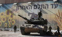 Binh lính Israel tập trung trên và xung quanh một chiếc xe tăng gần biên giới giữa Israel với Dải Gaza ngày 15/10. (Ảnh: Reuters)