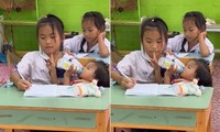 Hình ảnh cô học trò bế em trong lớp học ở Thái Lan. (Ảnh từ clip)