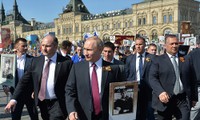 Tổng thống Nga Putin mang theo chân dung cha mình, ông Vladimir Spiridonovich Putin, người từng tham gia Thế chiến II, trong một cuộc tuần hành ở Moscow hôm 9/5. Ảnh: Tass
