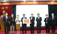 Đại diện UBTW Mặt trận Tổ quốc Việt Nam trao tiền ủng hộ cho đại diện Bộ Y tế. Ảnh: Mic.gov.vn