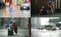 Mưa lớn khiến người và xe ở Hà Nội &apos;bơi&apos; trên phố
