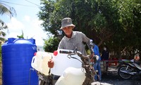 People in the Western region wait day and night to collect each can of water 