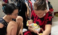 Em bé đang được Chủ tịch Hội Phụ nữ xã Phạm Văn Hai chăm sóc.
