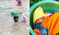 Cảnh sát dùng chậu nhựa cứu bé gái một tháng rưỡi khỏi nước lũ