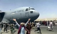 Người dân Afghanistan bám theo máy bay Mỹ đang cất cánh từ sân bay Kabul. Ảnh chụp màn hình