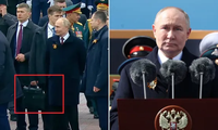 Tổng thống Nga Vladimir Putin phát biểu trên Quảng trường Đỏ dịp kỷ niệm Chiến thắng phát xít 9/5/2024 và trợ lý cầm vali đen được cho là cheget. Ảnh: Reuters.