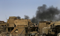 Thành phố Mosul hoang tàn trong ngày tuyên bố giải phóng 10/7. Ảnh: Reuters