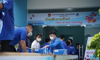 Các bạn thanh niên tình nguyện bốc vác, vận chuyển dụng cụ y tế, nhu yếu phẩm lên các Chuyến xe tuổi trẻ - San sẻ yêu thương.