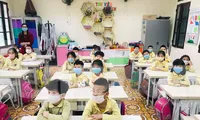 Học sinh trường tiểu học Phạm Hồng Thái (thành phố Nam Định) đeo khẩu trang, giữ khoảng cách an toàn khi đến lớp - Ảnh: Hoàng Long