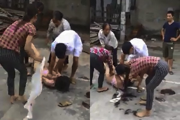 Nhóm người đánh ghen lột quần áo, cắt tóc cô gái sẽ bị xử lý ra sao? Cô gái bị nhóm người hành hung, lột đồ, cắt tóc một cách dã man. Ảnh cắt từ video.
