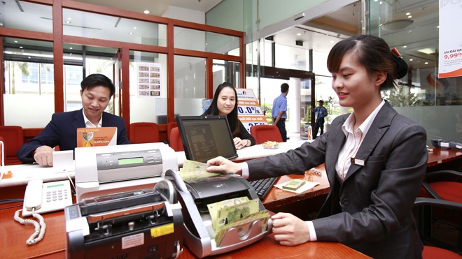 Ngân hàng có thể hạ lãi suất cho vay Một số chuyên gia cho rằng, nếu ngân hàng để nợ xấu ăn mất vốn thì cần để cho ngân hàng đó phá sản. Ảnh: Như Ý