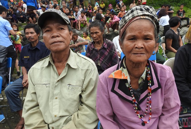 Vợ chồng người A Rem trốn bão trong hang đá Ông Đinh Nê và bà Y Rú trong một lần tập trung ngồi chờ đến lượt nhận quà cứu trợ.