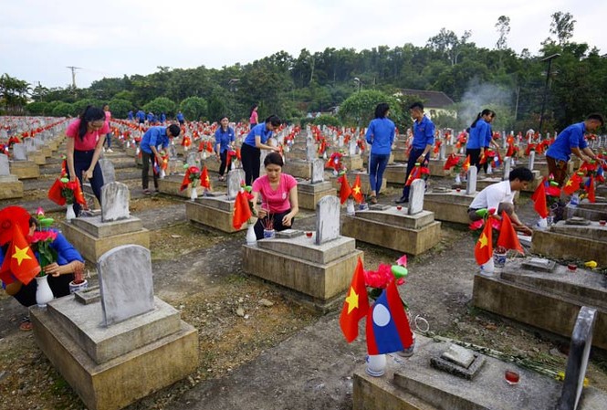 Viết tiếp khúc quân hành Thí sinh Hoa hậu Việt Nam 2018 cùng đoàn viên, thanh niên huyện Anh Sơn thắp hương, nến tại Nghĩa trang Việt – Lào. Ảnh: Như Ý.