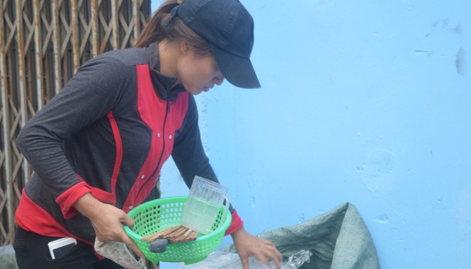 Chuyện đời “tỷ phú ve chai” Chị Hồng lượm những đồ còn tốt về dùng lại. Ảnh: Ngô Bình