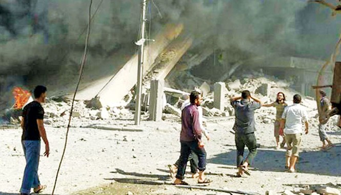 Bộ tứ bàn giải pháp chính trị cho Syria Sau một trận không kích ở Syria ngày 30/9. Ảnh: AP
