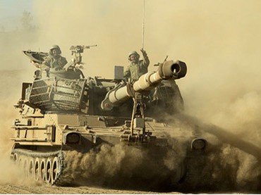 Israel tập trận bắn đạn thật Pháo binh Israel di chuyển đến địa điểm tập trận ở Cao nguyên Golan hôm 19-9