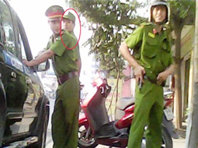 Vì sao kẻ trốn lệnh truy nã thành thiếu úy công an? Trần Hữu Nam (người đứng ở đầu xe) trong màu áo của lực lượng cảnh sát 113