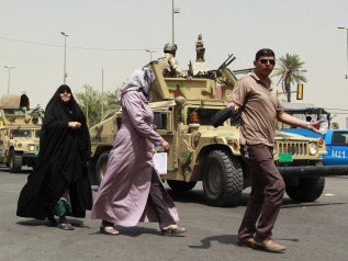 Đánh bom ở Iraq, 67 người chết Người Iraq đi trên một con phố được kiểm soát an ninh chặt chẽ