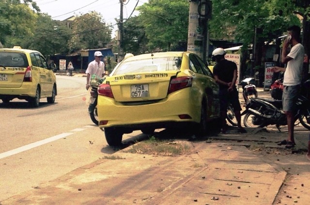 Taxi nát đầu sau cú đâm trực diện vào cột điện Taxi mất lái leo lên lề, găm thẳng đầu vào trụ điện