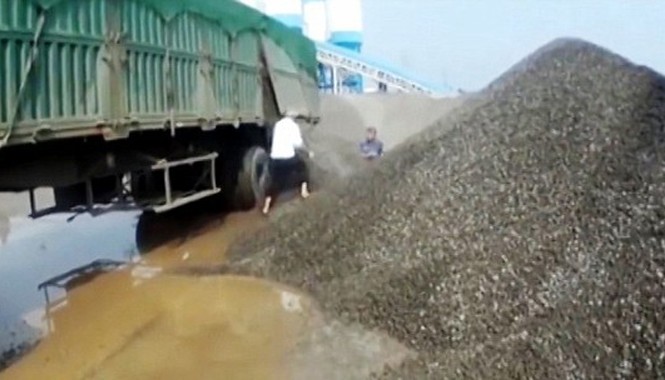 Tài xế đổ đá 'chôn sống' cảnh sát vì bị phạt Tài xế xe tải lập tức mở chốt container xả hàng tấn đá trực tiếp vào viên cảnh sát. (Ảnh: CEN)