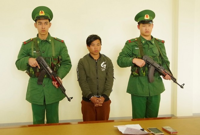Bán người yêu lấy tiền mua xe máy Sùng Seo Tráng (giữa) nghe đọc lệnh bắt tại Đồn Biên phòng Cửa khẩu quốc tế Lào Cai