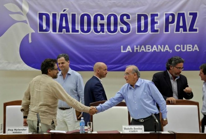 Hiệp ước lịch sử chấm dứt hơn 5 thập kỷ chiến tranh Đại diện Chính phủ Columbia Humberto de la Calle (phải) và đại diện FARC Ivan Marquez bắt tay sau khi đạt được thỏa thuận tại Havana, Cuba vào 5/8 vừa qua.