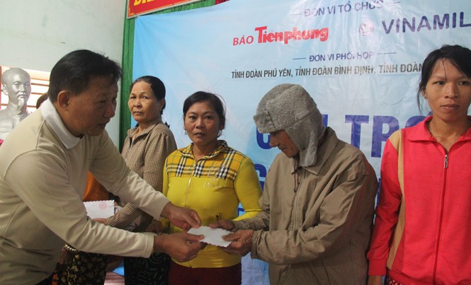 Quà của Vinamilk và Tiền Phong đến với bà con vùng lũ Quảng Ngãi Trao quà hỗ trợ cho người dân vùng lũ Quảng Ngãi. Ảnh H. Văn
