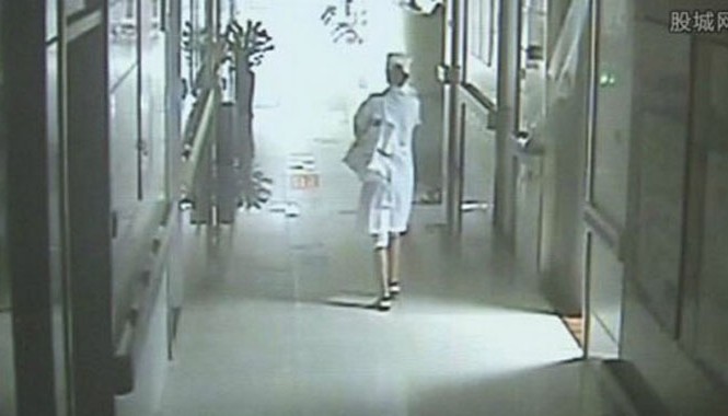 Màn kịch vụng về của kẻ giả y tá bắt cóc trẻ sơ sinh Camera giám sát ghi lại hình ảnh Zhao Yuan bế đứa bé rời bệnh viện. Ảnh: Gucheng.com.