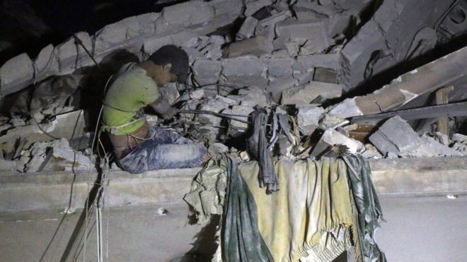 Gia đình 14 người thiệt mạng trong cuộc không kích ở Syria Nhân viên cứu hộ giải cứu bé trai 12 tuổi bị vùi lấp dưới đống đổ nát ngày 16/10.