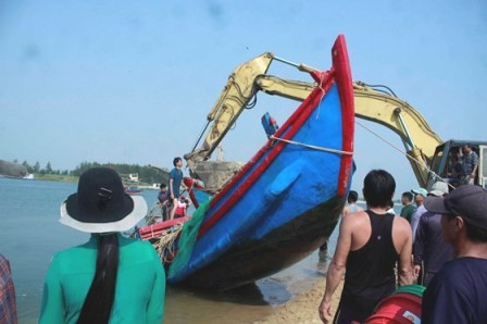 Nỗ lực trục vớt 2 tàu cá bị sóng đánh chìm Người dân đang nỗ lưc trục vớt hai tàu bị nạn. Ảnh Nguyễn Ngọc