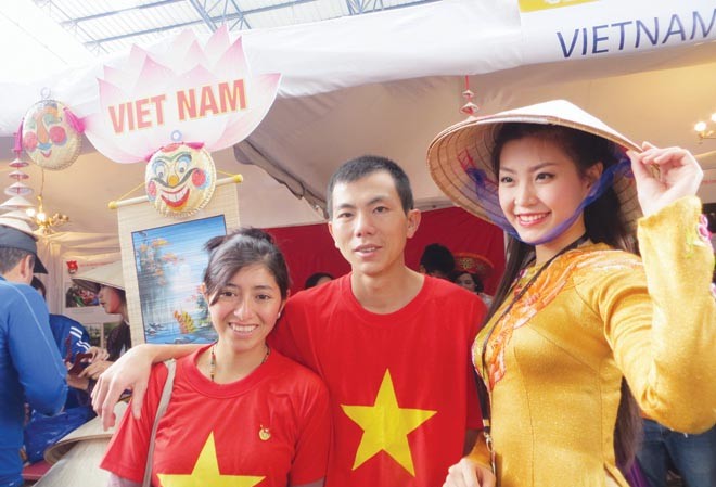 Người con tha hương trước gian hàng Việt ở Festival Vợ chồng Hiệp – Evelin chụp ảnh cùng bạn Nguyễn Lâm Diễm Trang, sinh viên Đại học Quốc tế TP Hồ Chí Minh, Miss Teen 2010, Nữ hoàng Cà phê