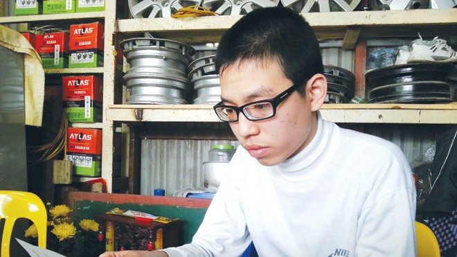 Học sinh bị đình chỉ vì không có hộ khẩu Sơn trầm ngâm trước bức thư. ảnh: nghiêm huê