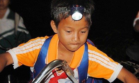 Học sinh đeo đèn pin trên đầu băng rừng đến trường từ 3h sáng Vượt hàng chục cây số đường rừng để đến lớp. Ảnh: Kh.Uyên