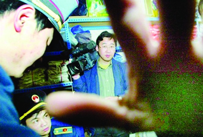 Báo tỉnh Trung Quốc: Điều tra hay không điều tra Một phóng viên ảnh Trung Quốc bị cản trở khi tác nghiệp Ảnh: CFP