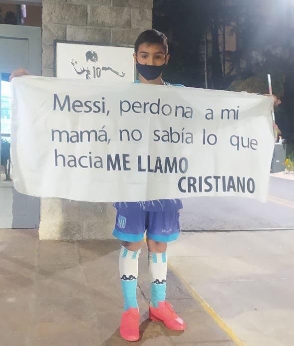 Messi fan boy holds a sign apologizing to his idol because his mother named him... Cristiano photo 2