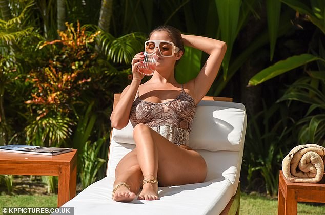 Lingerie model Demi Rose poses seductively for photos, showing off her eye-catching chest in photo 2