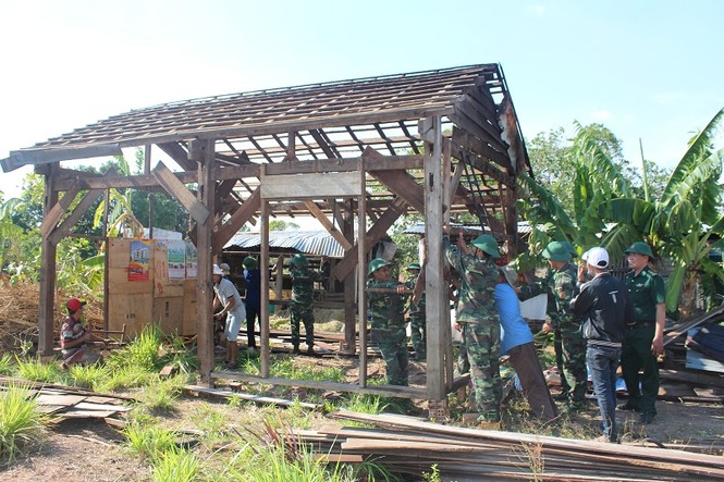 Cán bộ, chiến sĩ bộ đội biên phòng Đắk Lắk cùng với người dân sửa chữa lại nhà ở của người dân sau thiên tai (ảnh Nguyễn Dân)