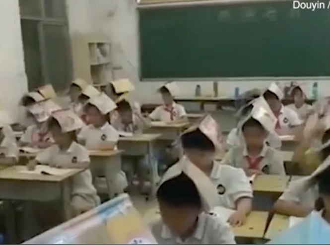Học sinh Trung Quốc đội sách lên đầu để
