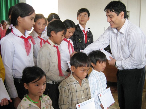 Anh Nguyễn Đắc Vinh trao quà cho học sinh nghèo tại xã Quảng Hòa