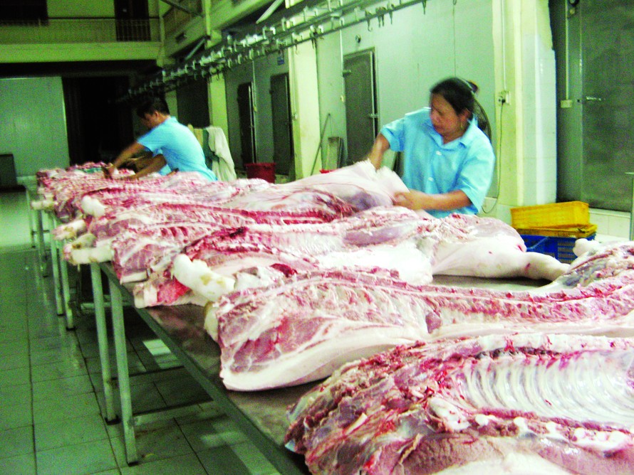 Xẻ thịt lợn tại lò mổ đạt chuẩn của Cty TNHH Minh Hiền. Ảnh: Phạm Anh