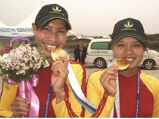 Từ chỗ tập cho khỏe, Hài (bên phải) trở thành cô gái vàng của rowing Việt Nam.