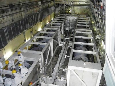 Các công nhân của Cty Điện lực Tokyo đang kiểm tra thiết bị trong cơ sở xử lý nước nhiễm xạ tại nhà máy Fukushima số 1 Ảnh: AP