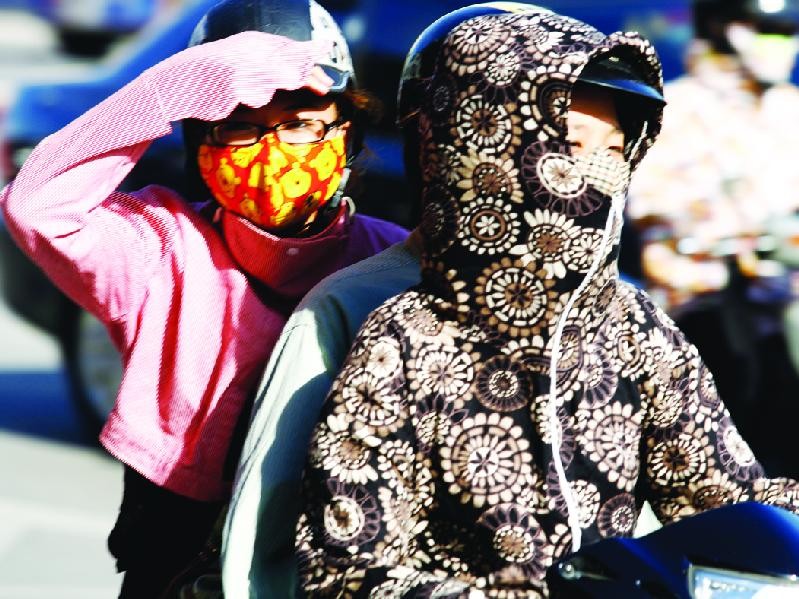Nhiều người Hà Nội mặc kín mít khi ra đường để chống nóng Ảnh: Hồng Vĩnh