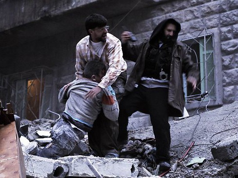 Xác một cậu bé được kéo ra khỏi đống đổ nát ở Aleppo hôm 7-1